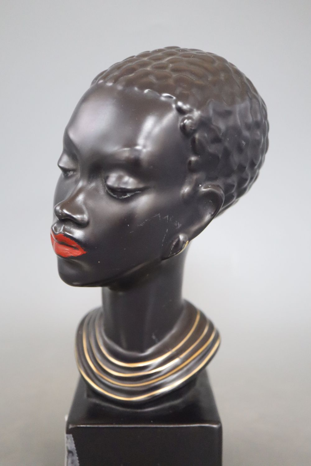 A 1960s ceramic bust of a tribal woman, signed, height 22cm